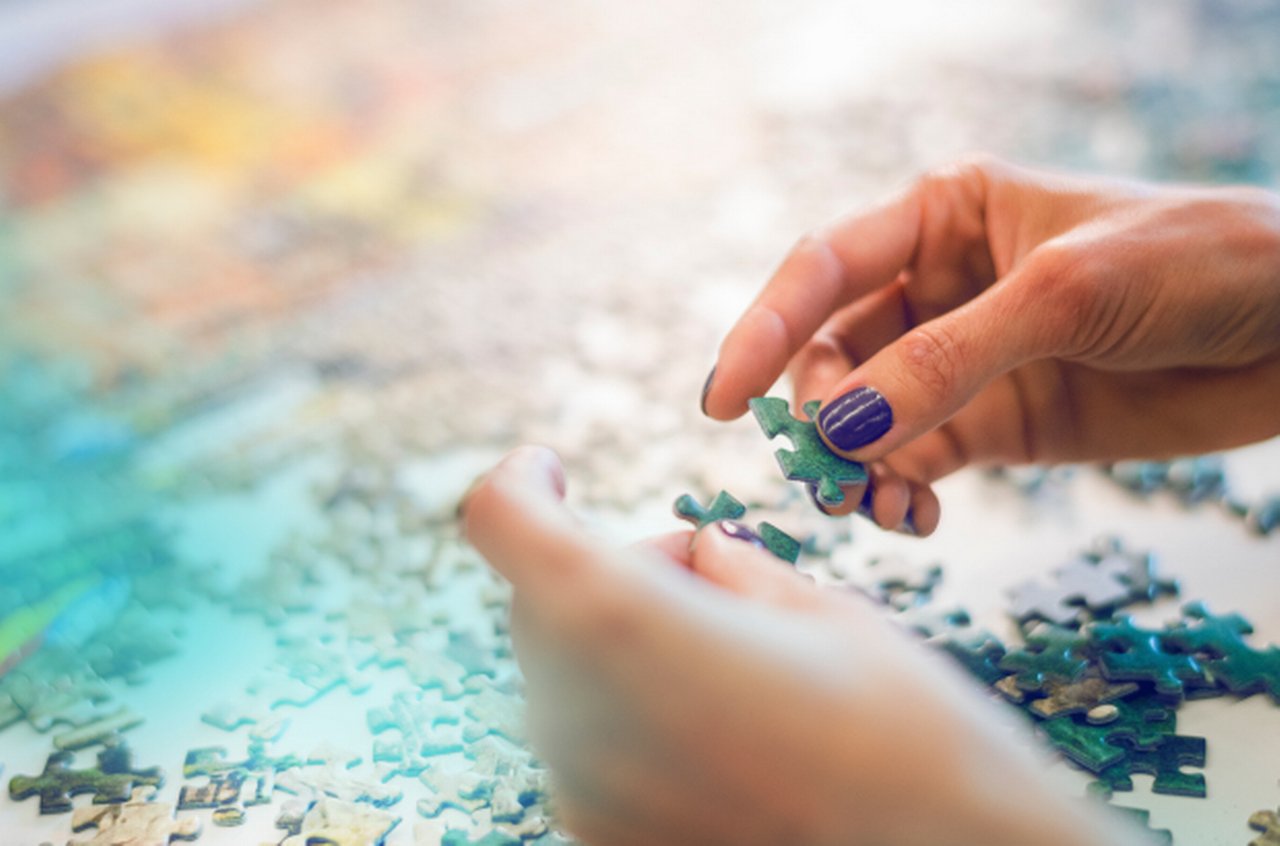 hands with piece of puzzle