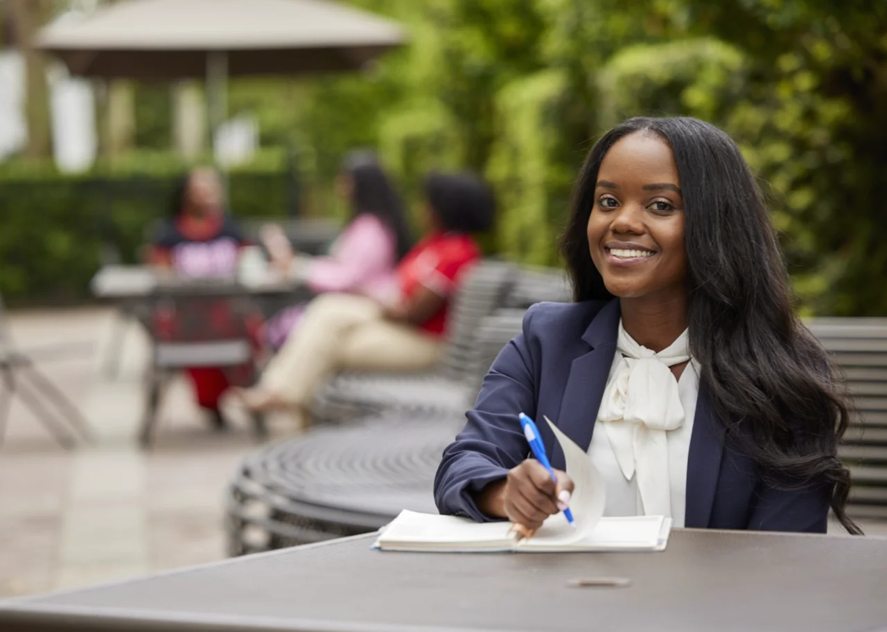 Woman with the paper and pen writing